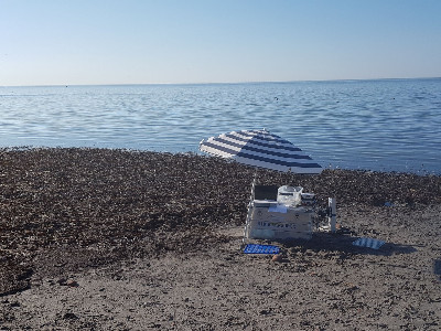 Measuring on the beach. The umbrella is to protect the equipment, not the researcher Measuring on the beach. The umbrella is to protect the equipment, not the researcher